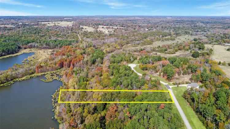 Waterfront lot for sale in Waters Edge Ranch featuring trees and amenities