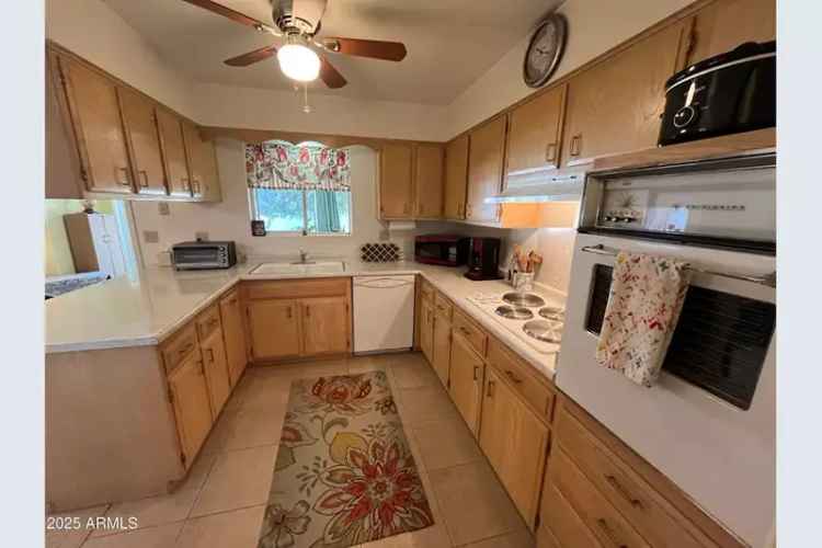 Buy house in Sun City with spacious kitchen and cozy Arizona room