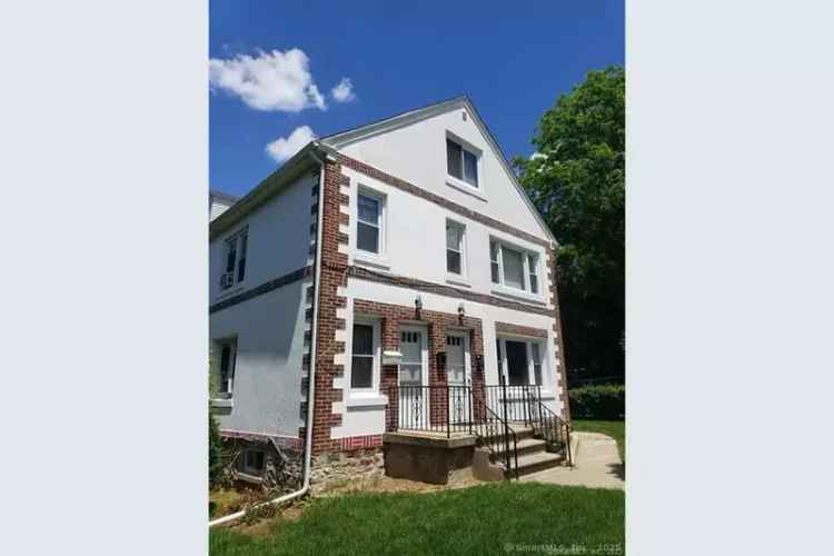 Invest in a three-family property in Waterbury with rental potential