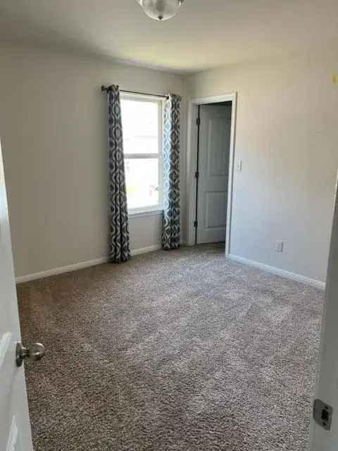 Rent Spacious Home with Game Room and Garage in Convenient Location