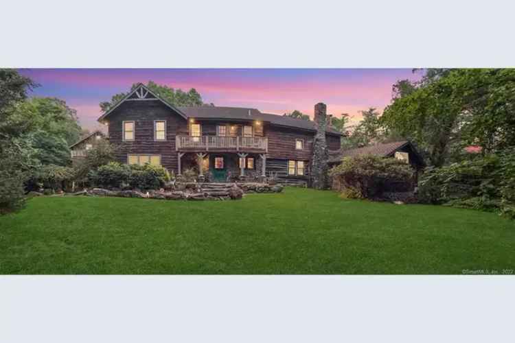 Unique log stone home for sale in Westport with private backyard