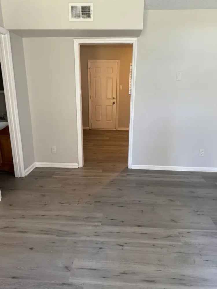 Rent Apartment Unit featuring hardwood floors and black appliances