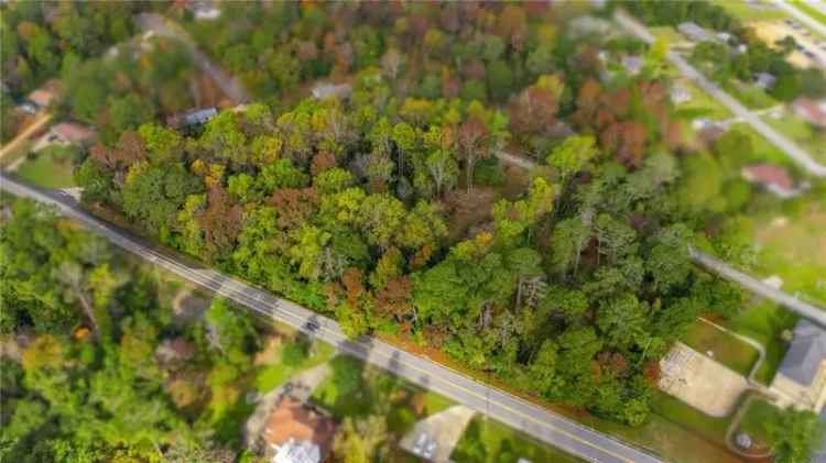 Buy wooded lot near Columbus with road frontage and utilities